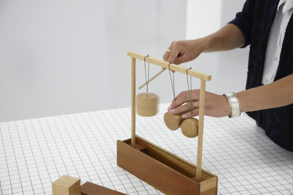 Installation view of Aurélien Froment Fröbel Fröbeled (2014). A visitor interacts with a wooden sculpture.