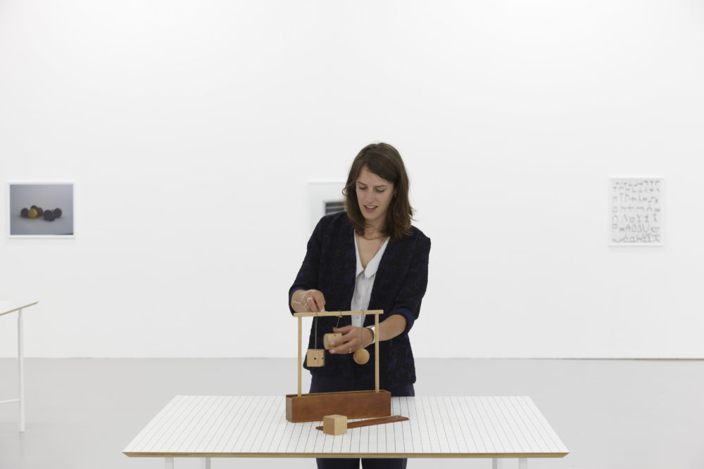 Installation view of Aurélien Froment Fröbel Fröbeled (2014). A visitor interacts with a wooden sculpture.