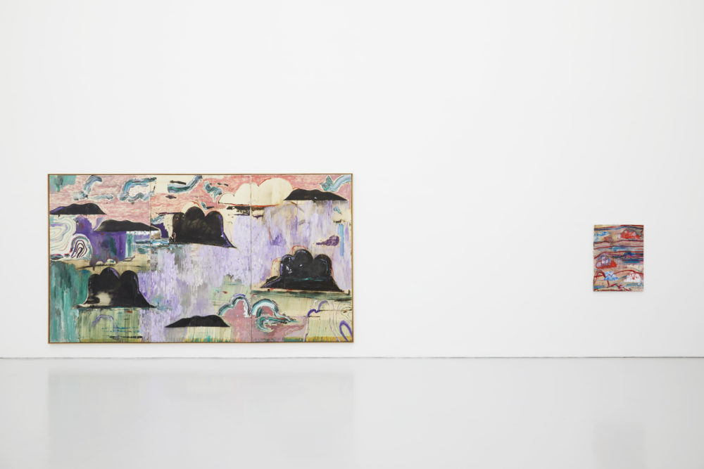 Two abstract paintings of clouds hang in the main gallery.