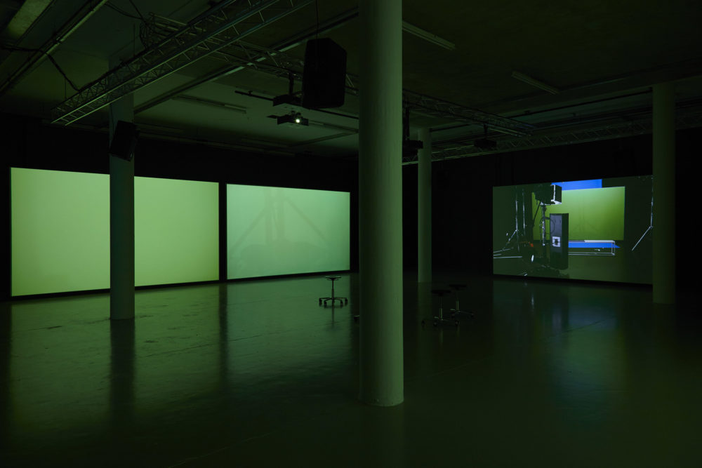 Three large screens are in the gallery - two are seemingly blank, one screens another screen.