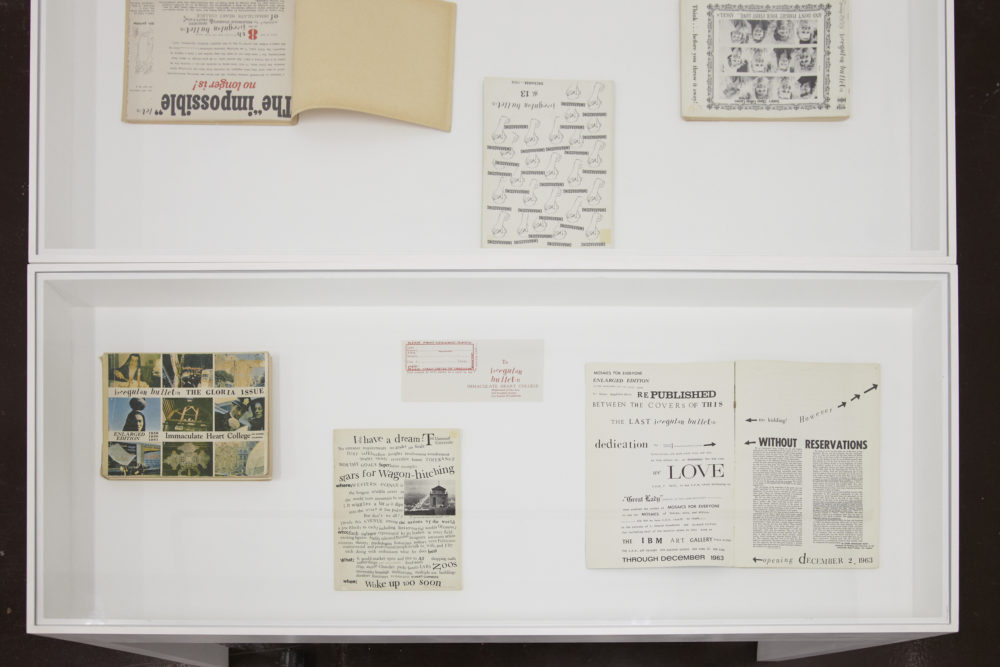 Installation view of Ciara Phillips and Corita Kent, Pull Everything Out (2012) Printed papers are displayed in a case.