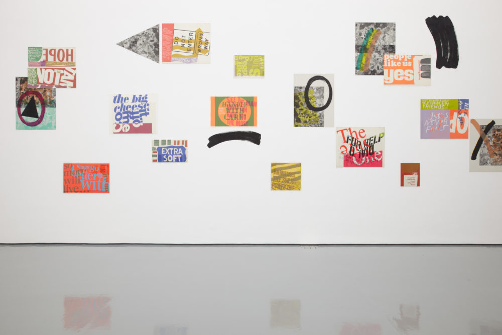 Installation view of Ciara Phillips and Corita Kent, Pull Everything Out (2012) Various brightly coloured screen prints hang on the wall.