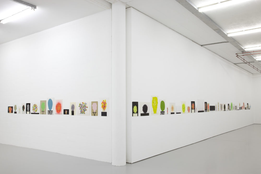 Installation view of David Batchelor Flatlands (2013). Small colourful prints hang on the gallery walls.