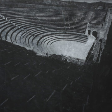 A print of a photograph of an amphitheater. The print is made from chalk on blackboard.