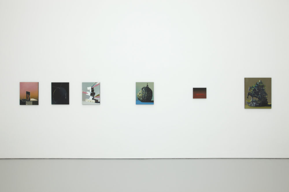 Installation shot: Nine unframed paintings hang on white walls.