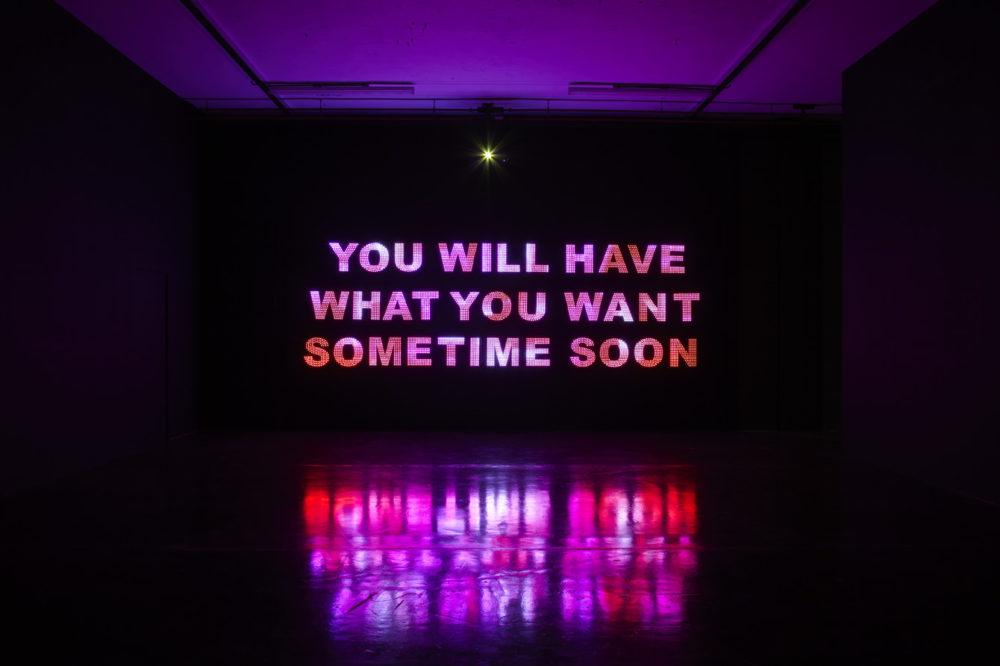Installation view of Savage, You Will Have What You Want Sometime Soon (2011). A projection of 