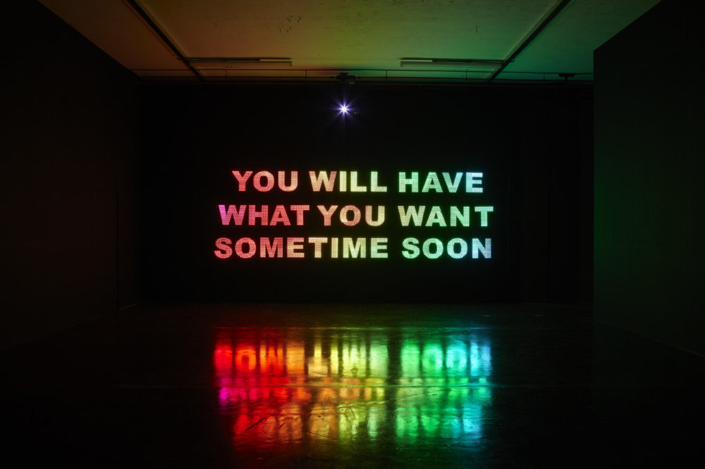 Installation view of Savage, You Will Have What You Want Sometime Soon (2011). A projection of 
