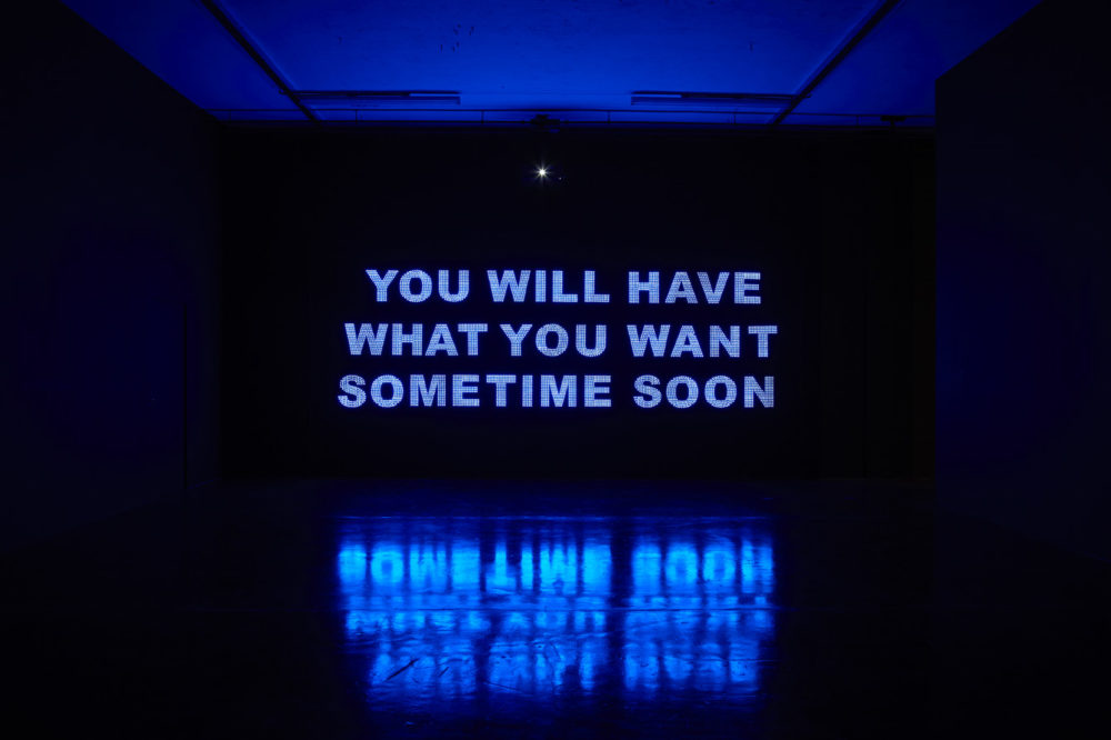 Installation view of Savage, You Will Have What You Want Sometime Soon (2011). A projection of 
