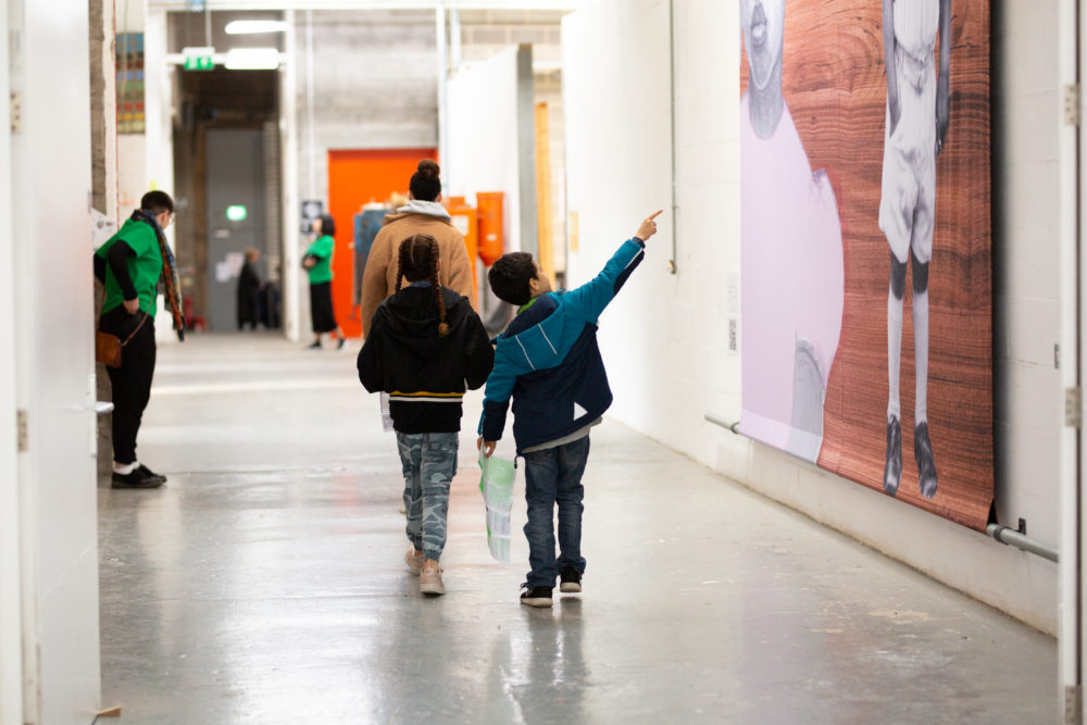 image of two children looking at exhibition in Spike Island gallery.