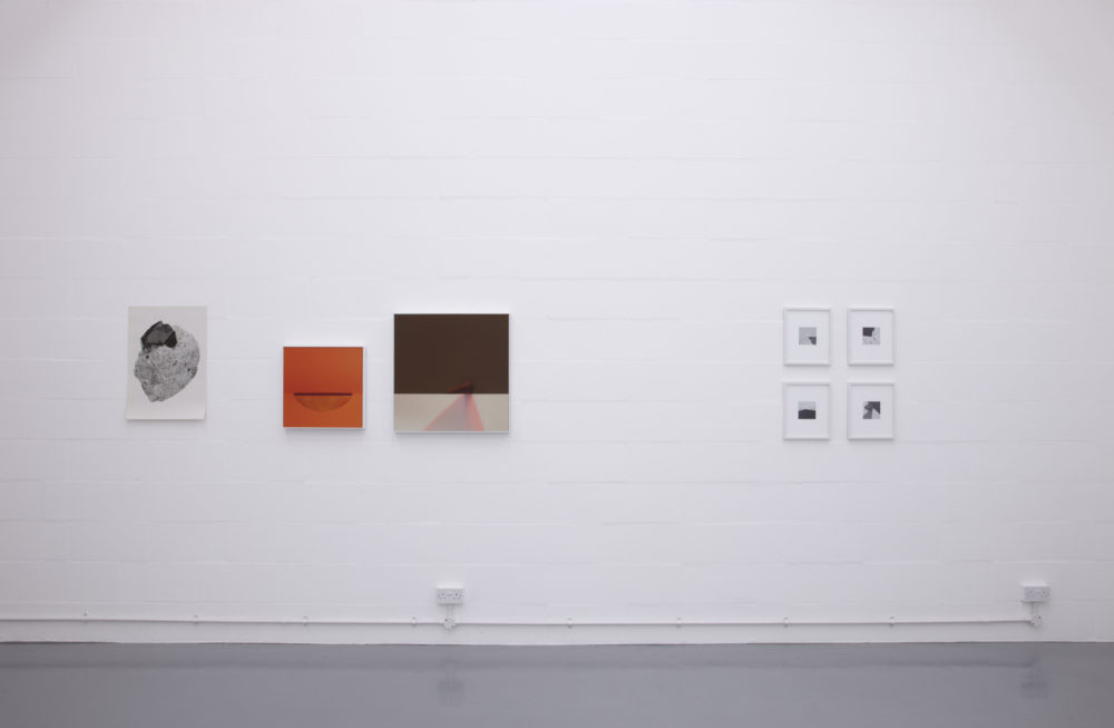 Installation view of Suzanne Mooney, The Edge of Collapse (2011). The gallery is painted white. Seven graphic art images hang on the walls.