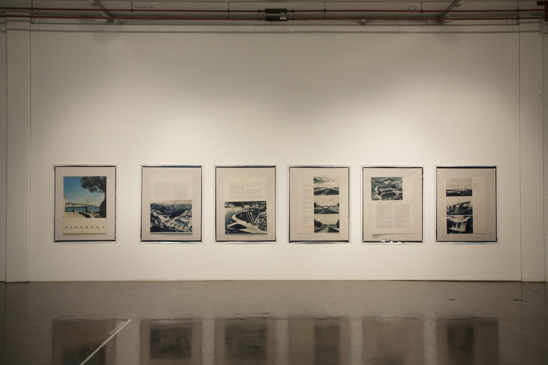 Installation view of Part-ilha, A River Ain't Too Much to Love (2011). Six framed images hang in the gallery. The images are accompanied by text that is too far away to read.