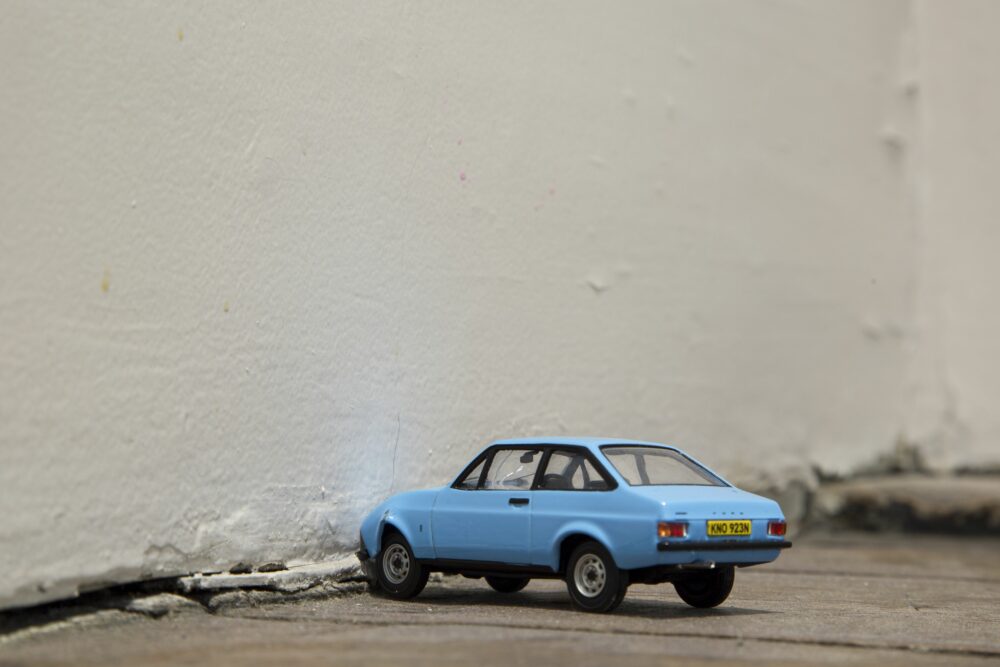 Photograph: A toy car has been crashed into a wall.