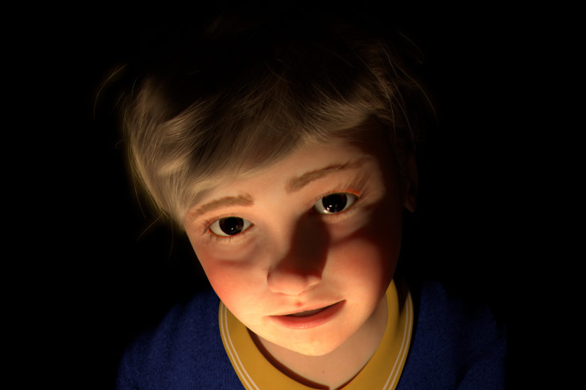 A head shot of a CGI young boy. He has fair hair, brown eyes, slightly rosy cheeks and is wearing a blue sweater over a yellow shirt. The background is black and his face is lit dramatically from below.