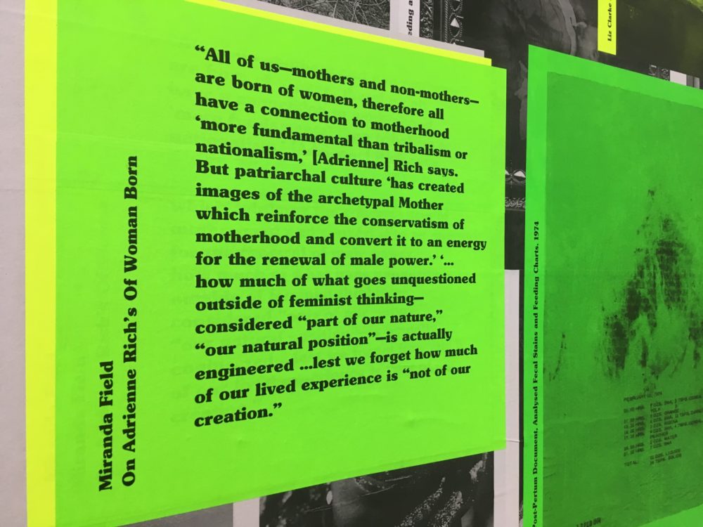 A neon green poster, pasted to a wall, with black bold serif text that reads:
