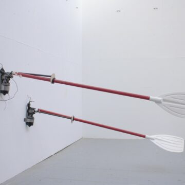 Two mechanical rowing oars bolted on the wall