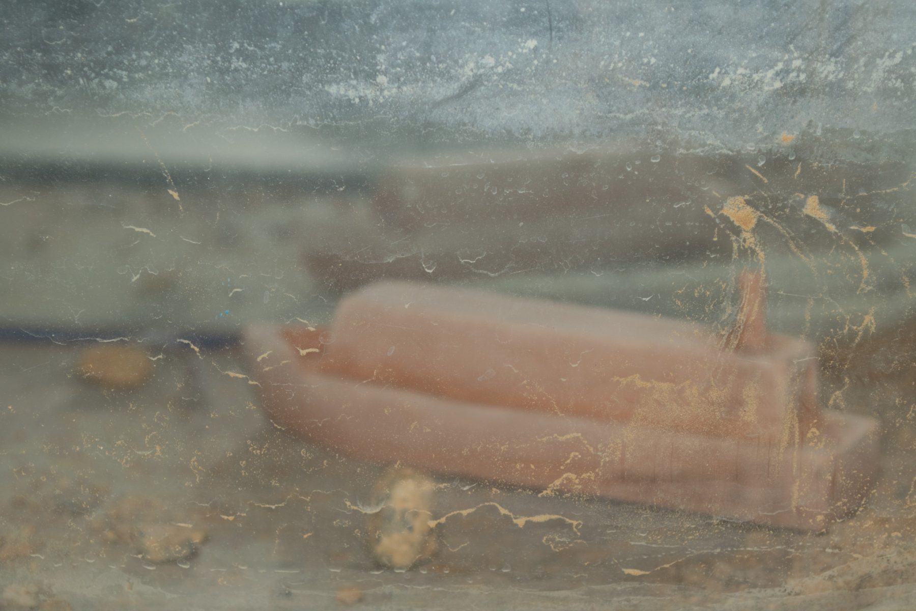 Image of Veronica Vickery artwork Graveyard, made from a mirrored fish tank and a ceramic fired form