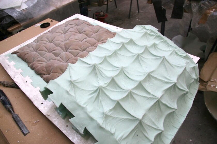 A studio process revealing a light brown dyed quilted cushion being de-moulded