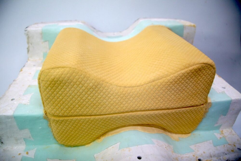 A studio process revealing a yellow plaster cast of an orthopedic cushion