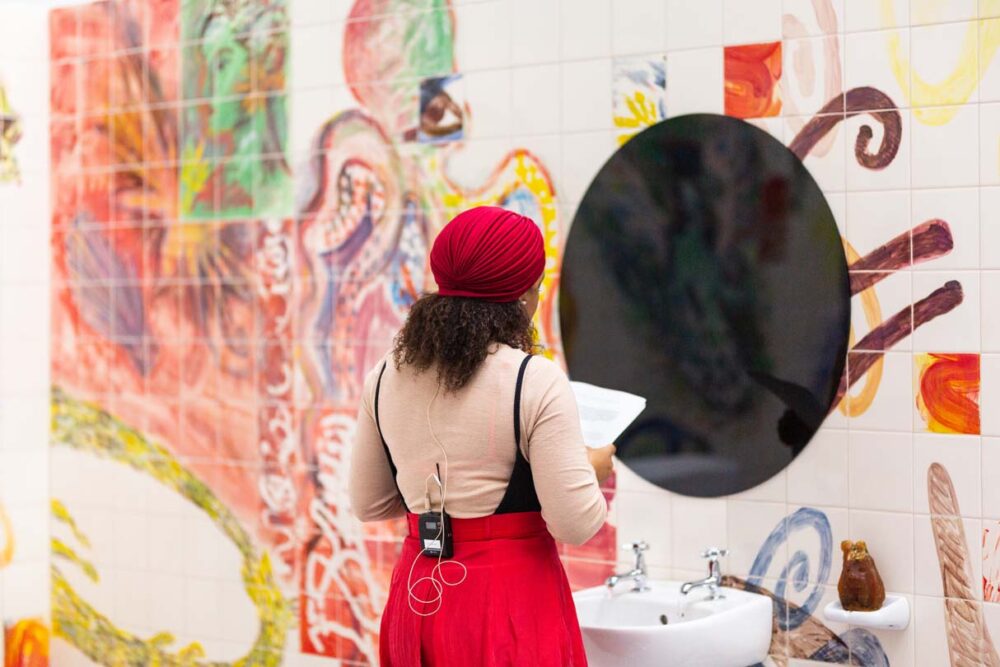 Photograph of Lucy Stein and Maria Christoforidou Performing the Question in the exhibition Wet Room at Spike Island