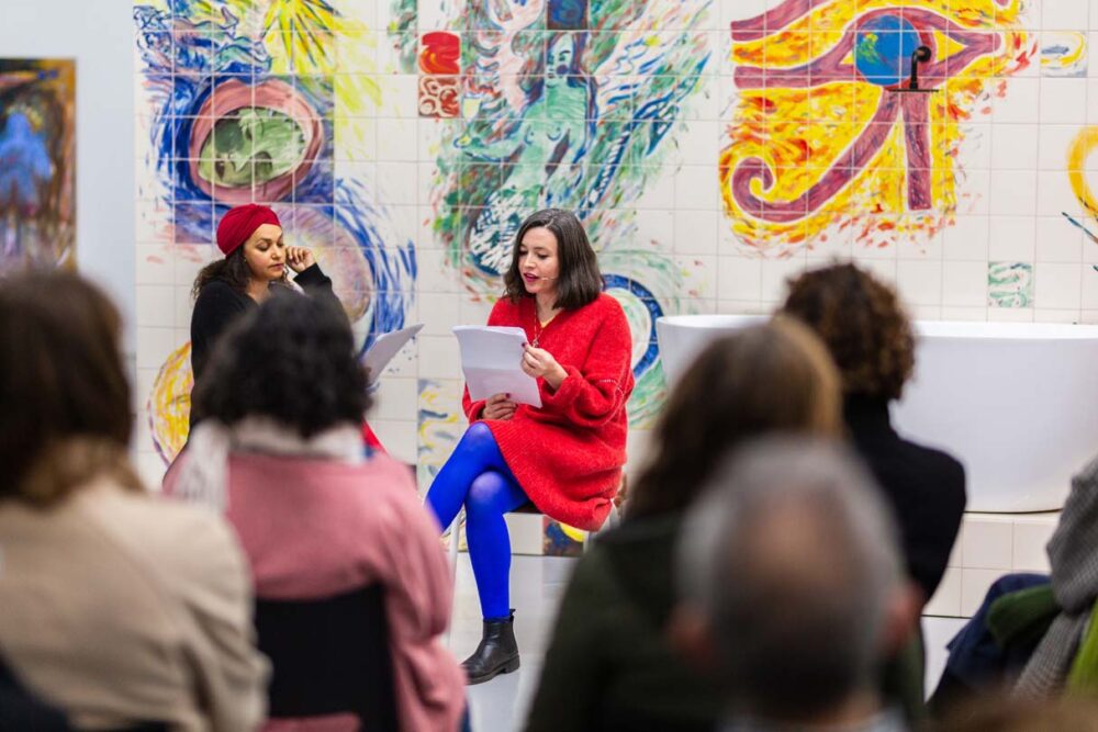 Photograph of Lucy Stein and Maria Christoforidou Performing the Question in the exhibition Wet Room at Spike Island