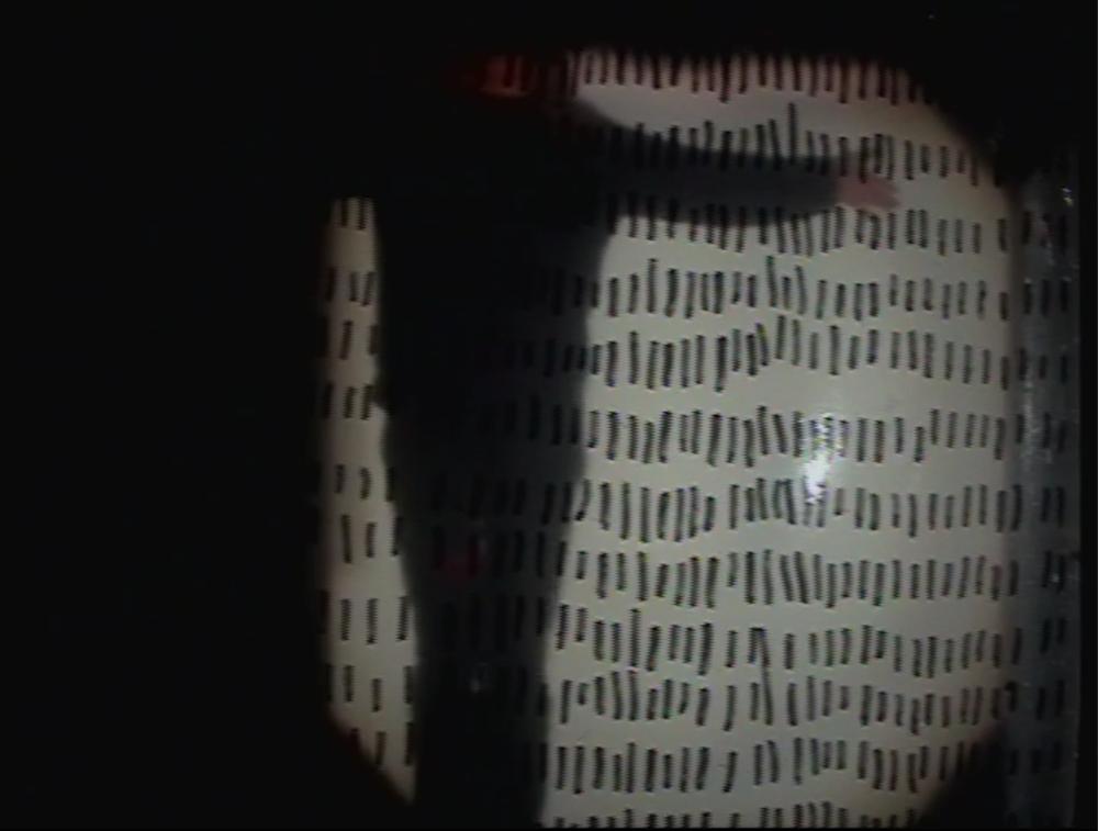 An image of a light projection with black lines and a white background, surrounded by a black vignette.