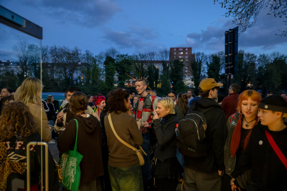 visitors stood outside entrance to Spike Island gallery at night