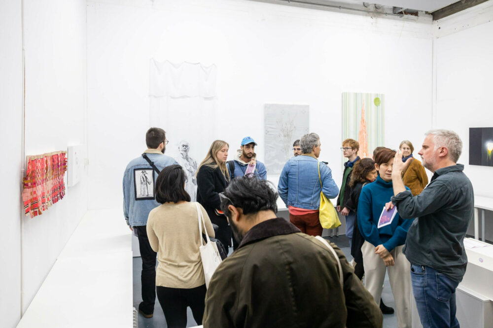 Image of multiple people in Young In Hong's gallery at Spike Island's Open Studios