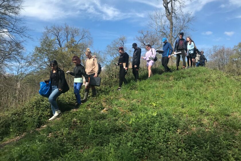 Photograph of the Hartcliffe Young People walking over a grassy hill