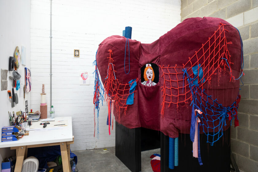 A fabric sculpture of a heart in an artist studio