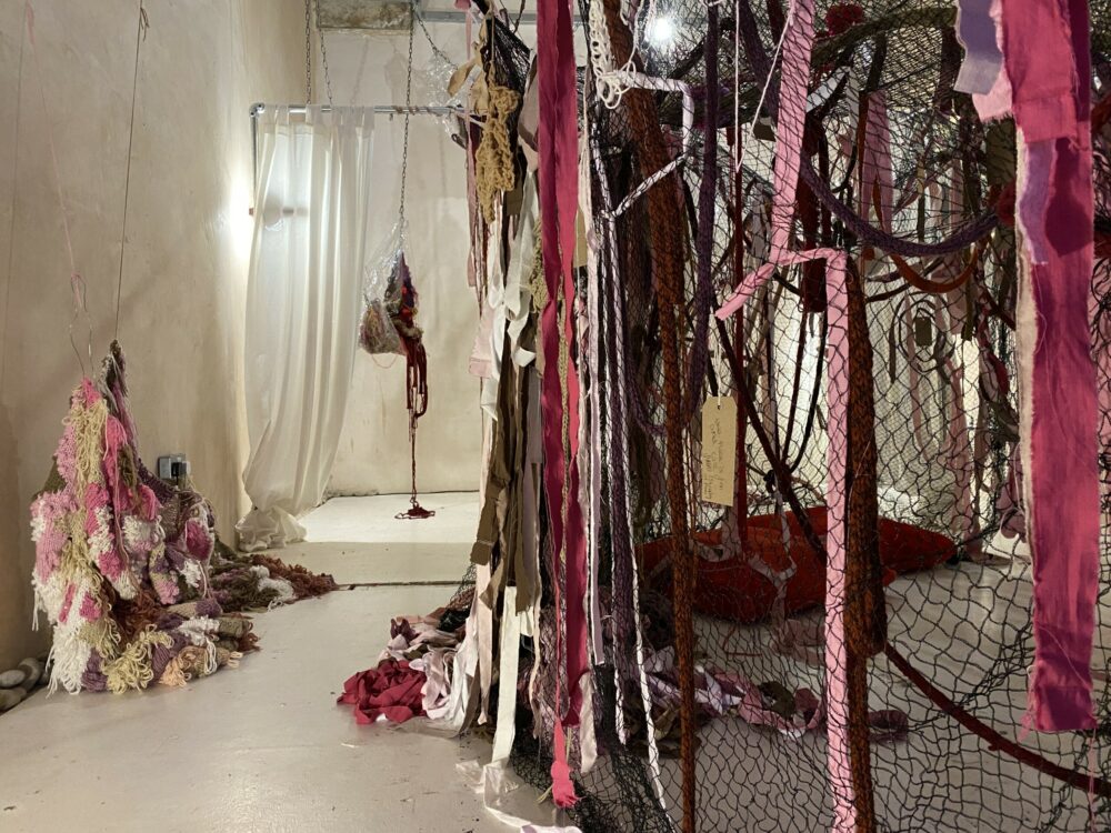 An art installation made of pink fabrics, incorporating textile pieces made by the public in engagement workshops.