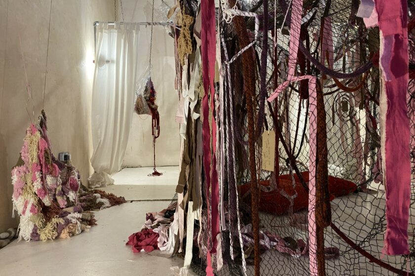 An art installation made of pink fabrics, incorporating textile pieces made by the public in engagement workshops.