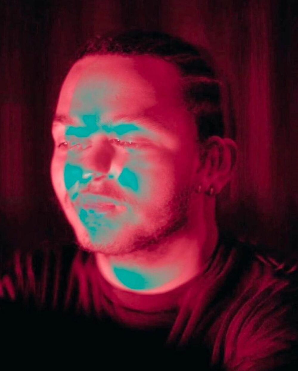 A portrait neon pink image of Louis Jack