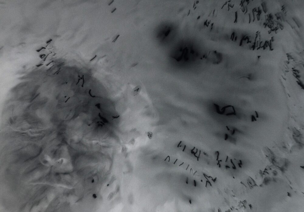 An grey image with textured areas created by manipulating analogue camera film