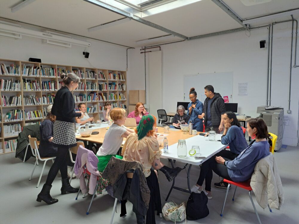 Group of people sat around a table undertaking a workshop